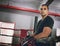 Dont mess with him. Portrait of a confident young male boxer leaning against ropes inside of a boxing ring at a gym