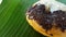 Donut with cheese topping and chocolate meses on banana leaves