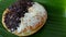 Donut with cheese topping and chocolate meses on banana leaves