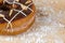 Donut chocolate glazing on wooden background.