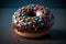 Donut decorated icing and sprinkles on black surface top view.