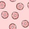 Donut doodle seamless pattern. Pink donut with topping on pink background. Cute cartoon background template