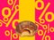 Donut with fruit jam on a fat thursday percentages purple background