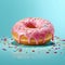 Donut isolated on a blue background. Cute, colorful and glossy donuts with pink glaze and multicolored powder