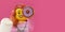 Donut lego in hand of minifigure on pink background