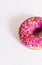Donut pink on a white background with a sprinkler.