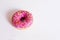 Donut pink on a white background with a sprinkler.