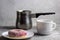 donut on a plate blurred coffee cups background