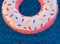 Donut shape swimming flot on dark blue pool