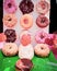 Donut wall display stand assorted chocolate glazed, sprinkle, sour cream, pink, board holder for doughnut at Thanksgiving party