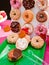 Donut wall display stand assorted chocolate glazed, sprinkle, sour cream, pink, board holder for doughnut at Thanksgiving party