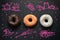 Donuts on a black background top view.