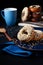 Donuts with chocolate glaze and waffle crumbs on a blue plate