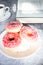 Donuts with coffee and milk. Donut with pink frosting