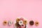 Donuts Doughnuts with Chocolate and Sprinkles on Pink Background