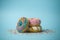 Donuts doughnuts of different colors on a blue background with multi-colored festive sugar sprinkles. Holiday and sweets, baking