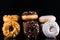 Donuts or Doughnuts Tower on Dark Background. Donut Stack Pile Food Background