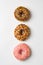 Donuts glazed with sprinkles on a light background