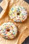 Donuts glazed with various sprinkles