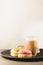 donuts in glazes and a glass of a cappuccino /donuts in glazes and a glass of a cappuccino on a black tray on a white background