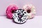 Donuts with icing on pastel pink background. Sweet donuts. Candies on wooden background. Party food concept with copy space.