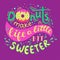 Donuts make life a little bit sweeter. Hand Lettered Phrase on lilac background