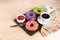 Donuts, milk and hot coffee on a wooden background.