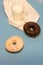 Donuts, milk and white napkin on a blue background