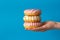 Donuts on the palm on a blue background. close-up