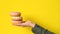 Donuts on the palm on a yellow background close-up
