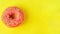 Donuts on pastel yellow background.