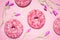 Donuts on pink background with flowers. Strawberry sprinkles on sugar glazed dessert. Girly, pastry, sweet fast food, bakery