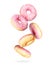 Donuts with pink glaze frozen in the air on a white background