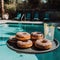 Donuts served by the pool. Tasty breakfast on wooden board.