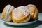 Donuts sprinkled with powdered sugar.