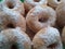 Donuts sprinkled with powdered sugar in a traditional shop