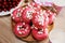 Donuts with sprinkles on pink background. Sugar, calories, homemade sweets concept