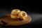 Donuts with sugar on a wooden plate over a dark table background