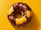 Donuts topped with chocolate The yellow background