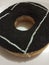 Donuts topped with dark chocolate with a very attractive white line on a white plate