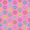 Doodle flowers seamless pattern, colorful floral background. Multicolored bright simple bud with petal on pink backdrop, hand