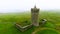 Doonagore Castle aerial foggy orbit view, iconic landmark, County Clare, Ireland