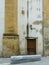 door in the back wall and bench in marble stone of the church of SÃ£o Bartolomeu in the city of Coimbra.