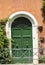 The door and beautifully worn wall of a house in the Trastevere neighborhood of Rome,