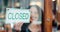 Door closed sign, happiness and restaurant woman, small business owner or employee end service, store or cafe day