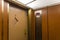 Door closing in elevator with wood paneled walls