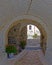 Door and flowers pots under a vintage arch