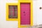 Door and fuchsia window with yellow edges in Nijar, Almeria, Andalusia, Spain