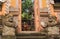 Door or gate to enter into traditional balinese garden lanscaping detail with statues