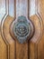 Door handle like antique head on the entrance of a house on Malta. Italian traditional doorknob.
